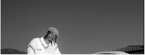 Snoop Dogg seated outdoors